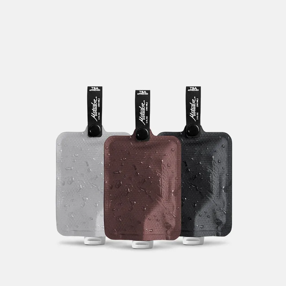 Matador FlatPak Toiletry Bottle 3 Pack, Ultralight Soft Travel Bottles, 5x Lighter Than Silicone, TSA Friendly, Flip Cap, Charcoal and Garnet and Arctic White - MATFPB3001MLT2